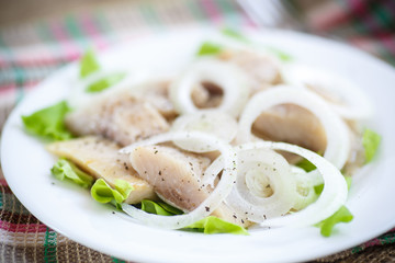 pieces of salted herring with onions