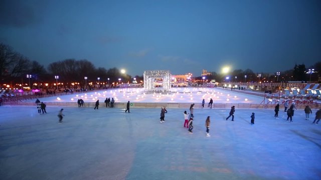 People are skating on evening rink at The Central Park 