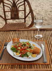Hard boiled egg with vegetable salad and baguette