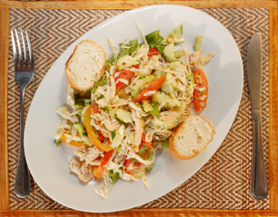 Asian vegetable salad with chicken and baguette