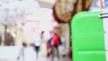 Motorbike front light on showcase in shop, people walk around