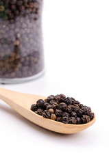 Black pepper in wooden spoon
