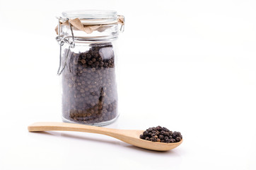 Black pepper in wooden spoon