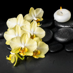 Fototapeta na wymiar beautiful spa setting of yellow orchid phalaenopsis and candles