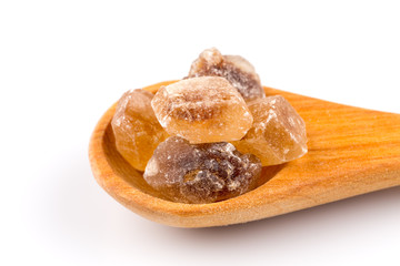 brown caramelized sugar in a wooden spoon