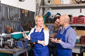 Auto service crew near tools