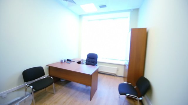 Sofas at reception of small empty office with furniture
