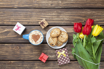 Cup of cappuccino with heart shape and cookies