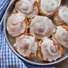 Delicious Looking Cinnamon Buns Hot out of the Oven with Sweet Icing, Perfect for a Fall or Winter Morning