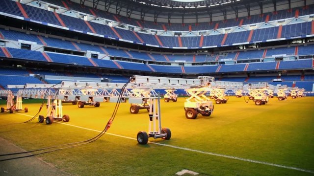 Light system for growing grass at empty football stadium