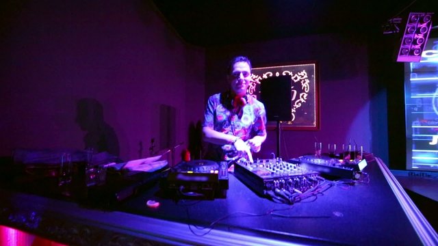 Camera moving up, down, on and from DJ table at night club