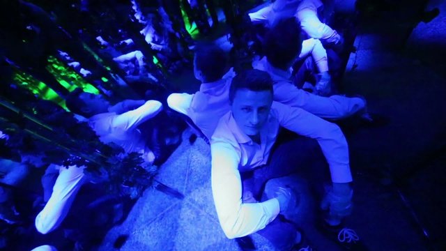 Top view to man in gloves sitting on the floor of labyrinth