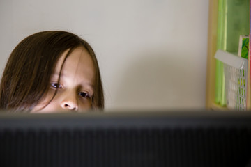 Young girl looking at computer screen