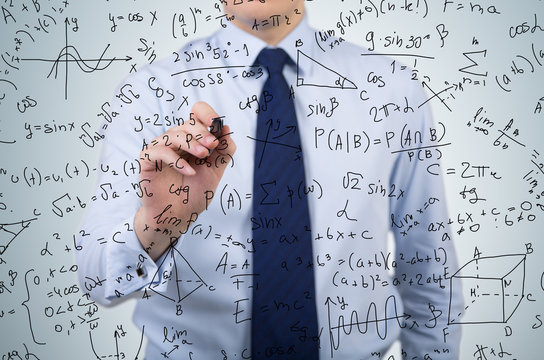 businessman drawing formulas