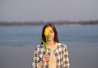 the girl with a tulip is situated on the bank of the river