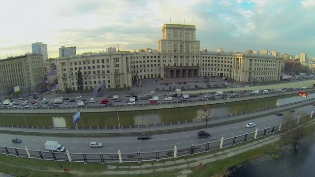Pond in park Lefortovsky and traffic on quay of Yauza river