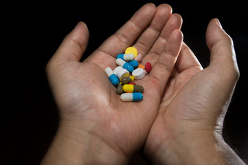 Medicine pills and capsules in hands
