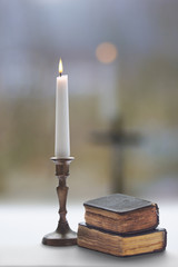 Old two prayer  books and burning candle with a candlestick © agephotography