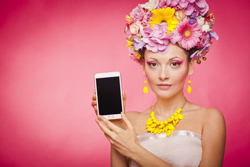 Smartphone app demonstration by woman in flowers - 80206891