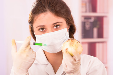young beautiful woman biologist experimenting with white onion