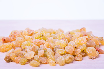 Dried raisins on a wooden plate