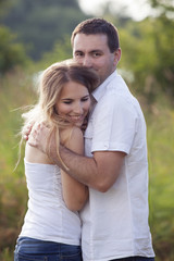 Fototapeta premium A young couple in love hugging outdoors