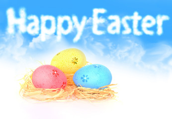 Happy Easter. Colorful eggs lying on hay.