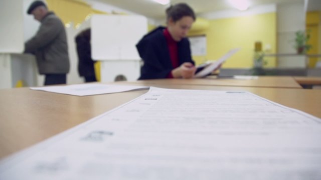 Ballot list lies on table with woman which reads