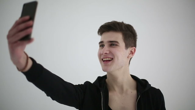 Handsome fit shirtless young man taking selfie