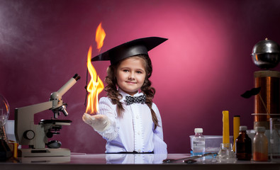 Cute girl conducts physical experience in lab