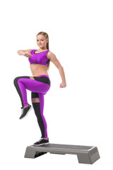 Lovely athletic girl training on stepper