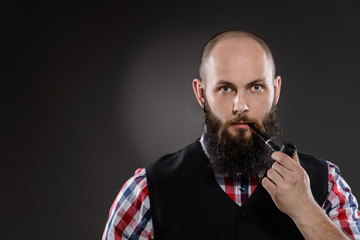 Bald bearded man in checkered shirt