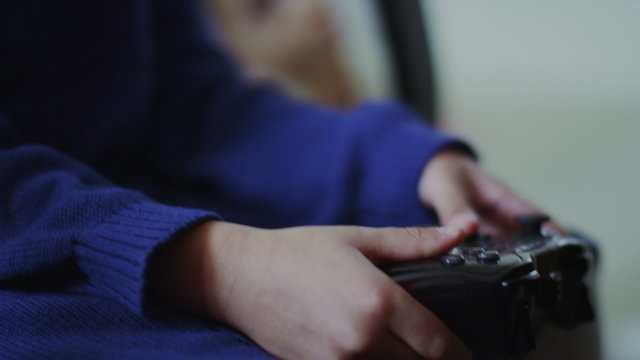 Slow motion young girl playing video games