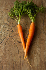 delicious organic carrots on a brown background