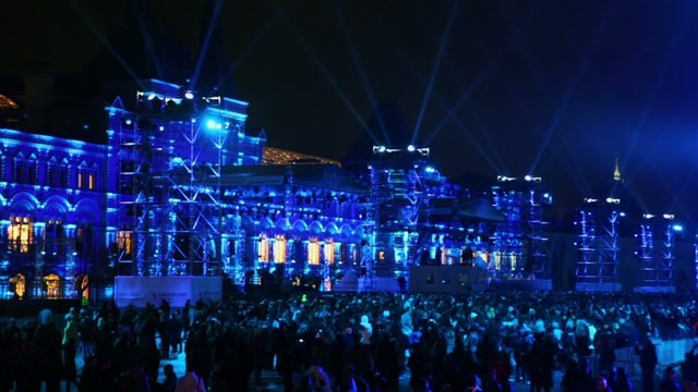 Projectors rays above crowd during Circle of Light festival