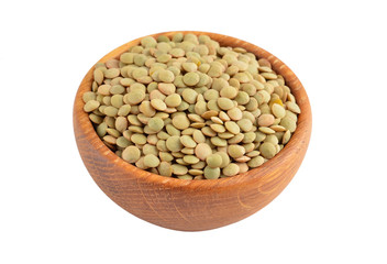 Green lentil in wooden bowl, isolated on white background