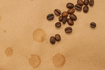 Fototapeta na wymiar coffee beans and cup spot on kraft background