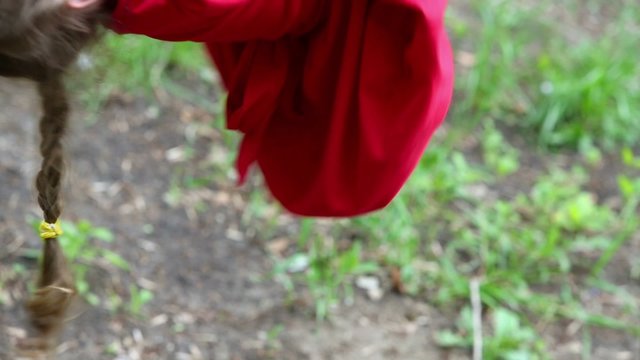 Young girl hangs upside down and then jumps to ground