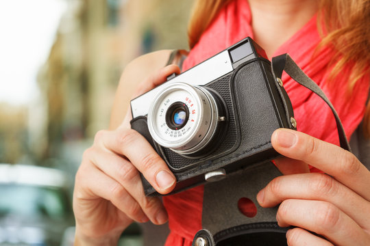 Woman photographer with old lomo camera.