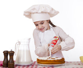 Cooking and people concept - smiling little girl in cook hat