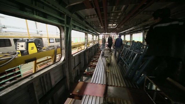 Workers weld inside wagon at Mytishchi Metrovagonmash factory