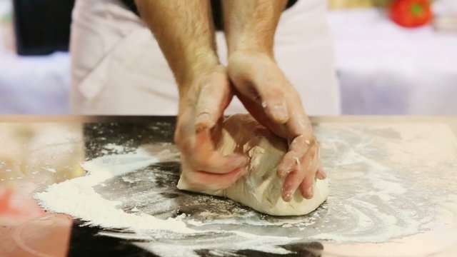 Male hands knead dough for cooking tasty and healthy meal
