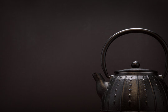 Image of traditional eastern teapot over dark background