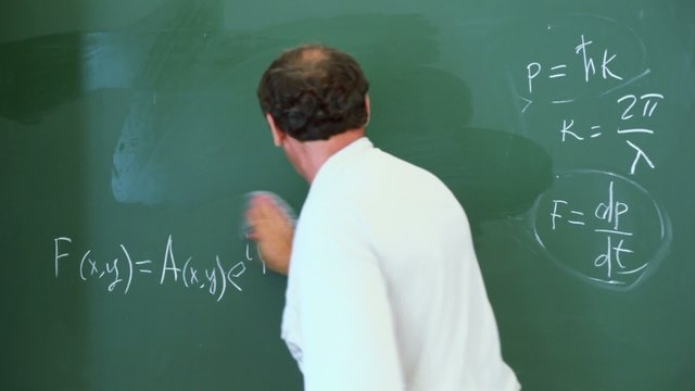 Professor cleans board with formulas appurtenant to lasers