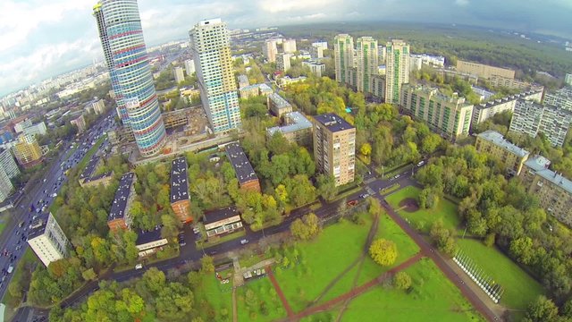 Day view: panorama of modern city with large park and forest