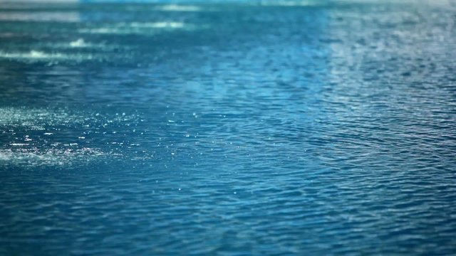 Two sportsmen dives in water of pool during twofold jump
