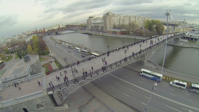 Cars ride by quay near Patriarshy pedestrian bridge 