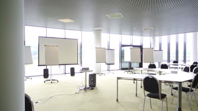 Background for projector in small modern auditorium with desks