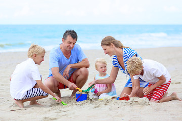 Happy family with kids enjoying beach vacations