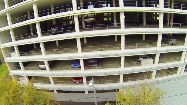 Day view: many cars parked in multi-level parking, aerial view